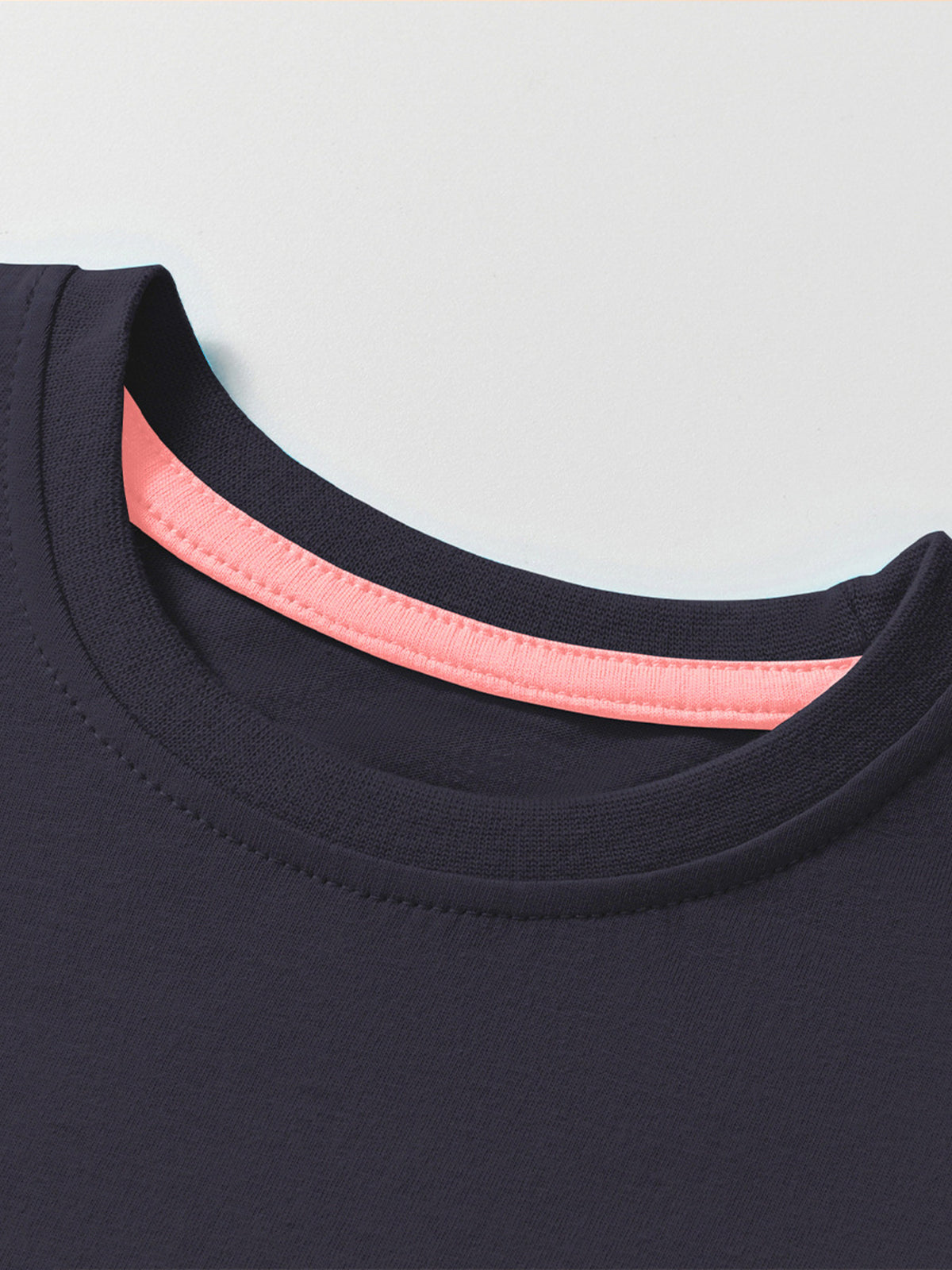 Navy blue cotton crew neck t-shirt with pink trim detail at neckline.