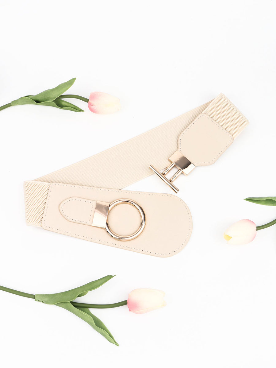 Cream elastic belt with gold ring and T-bar buckle detail