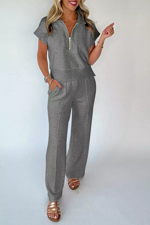Chic dark gray half-zip polo short-sleeve top and wide-leg pants set with gold zipper detail.