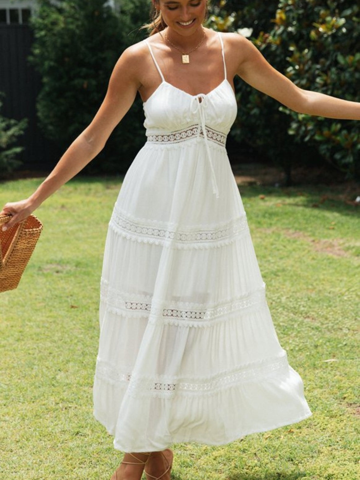 White lace trimmed tiered midi dress with spaghetti straps and tie front.