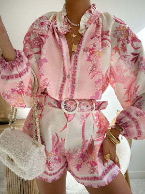 Pink floral print button-up shirt and shorts set with ruffled collar and balloon sleeves.