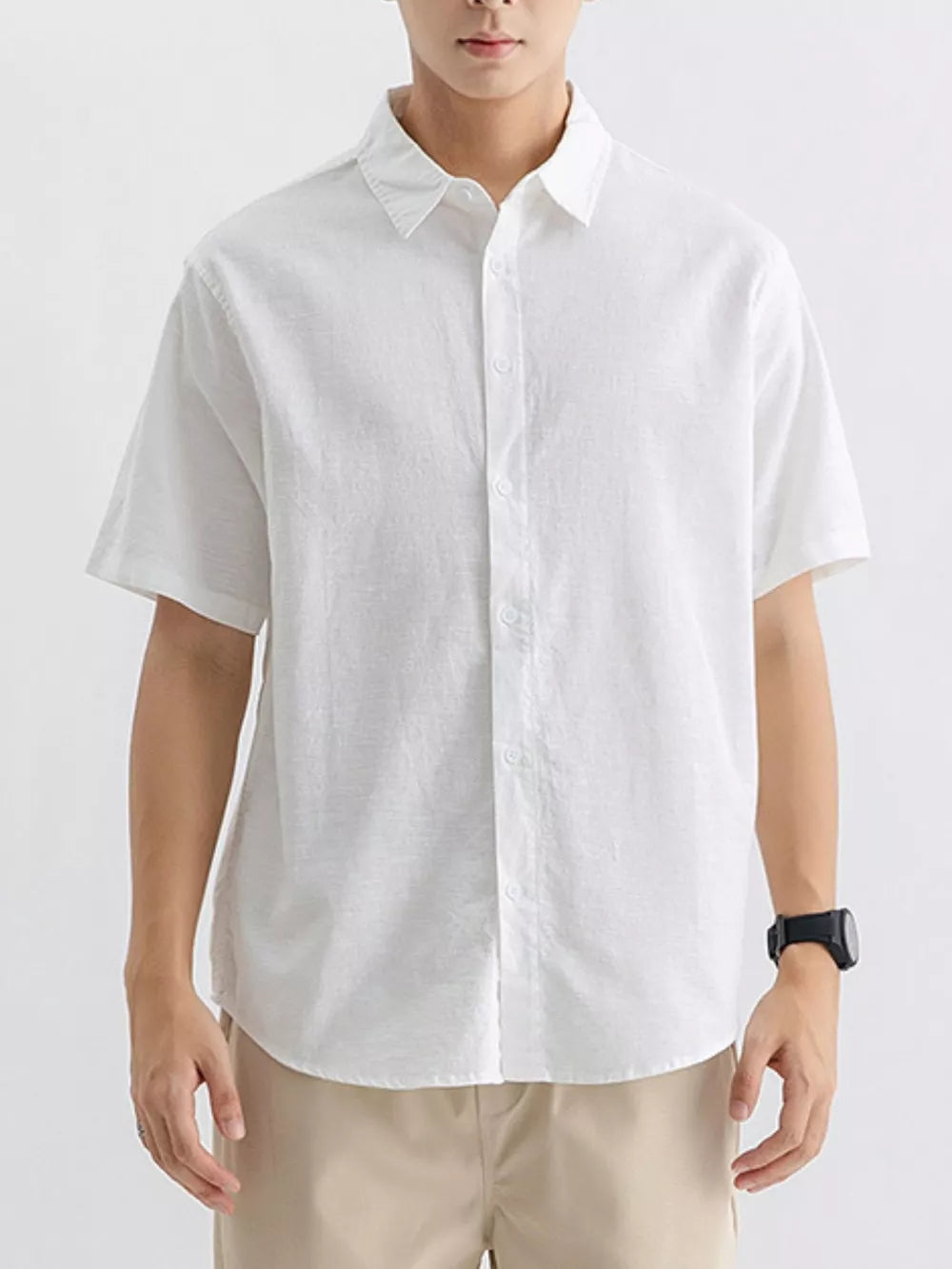 Men's white short-sleeve cotton button-up overshirt with a classic collar.