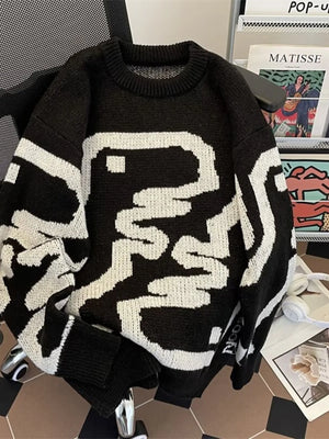 Black oversized sweater with abstract white pattern, ribbed hem and crew neck.
