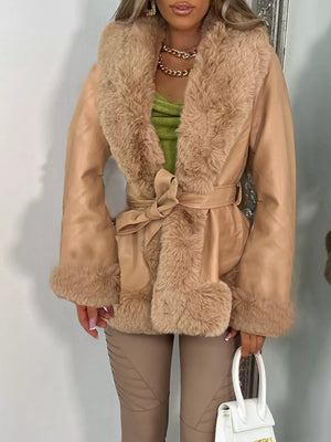 Belted beige faux fur coat with textured sleeves and collar, cinched waist.