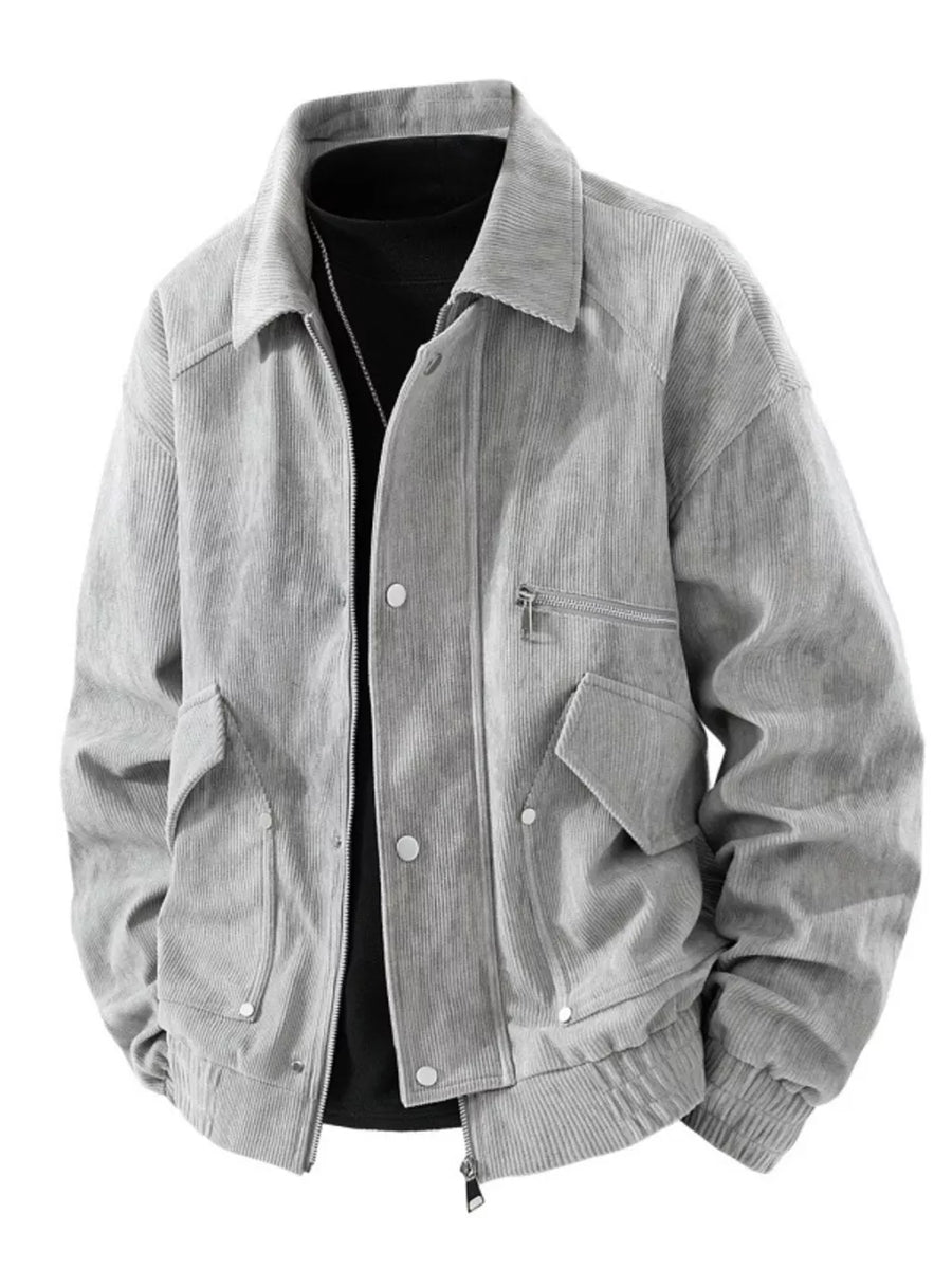 Grey corduroy trucker jacket with buttoned pockets and zip closure.