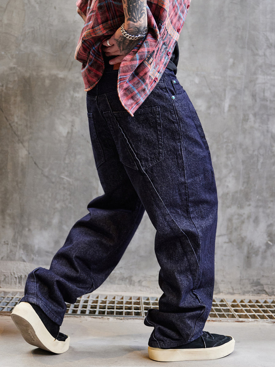 Men's wide leg indigo jeans in dark blue cotton denim with contrast stitching.