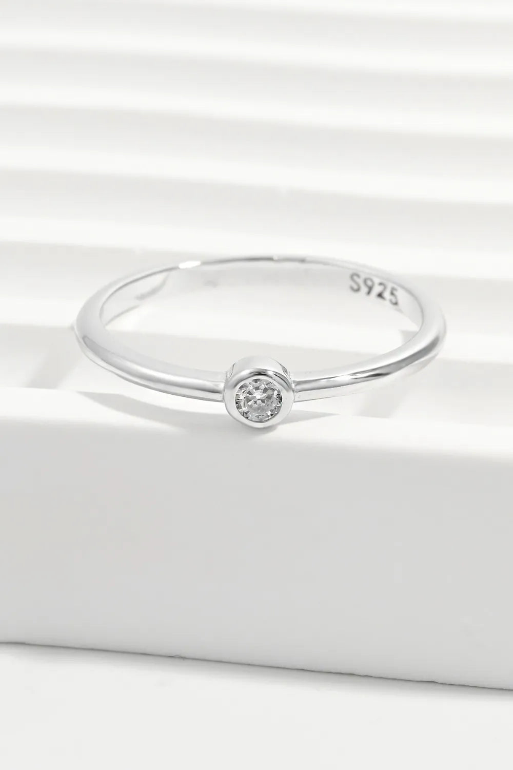 Solitaire silver ring with a single sparkling zirconia stone on a polished sterling silver band.