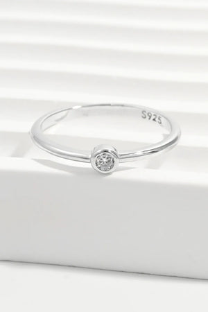 Solitaire silver ring with a single sparkling zirconia stone on a polished sterling silver band.