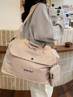 Beige duffel bag with black logo and detachable pouch, worn crossbody.