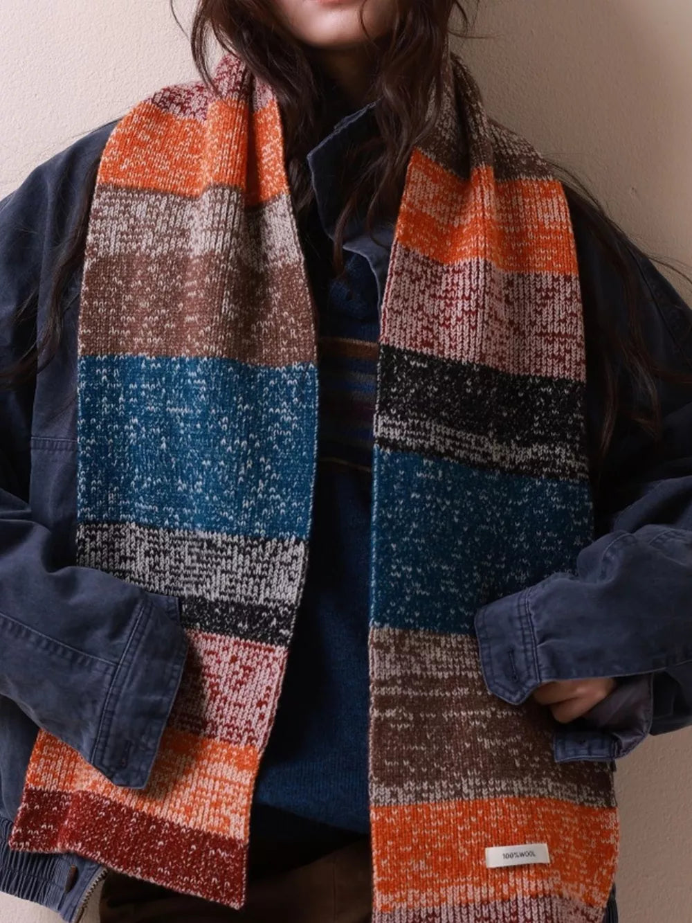Textured wool scarf with color block stripes in orange, brown, blue, and black.