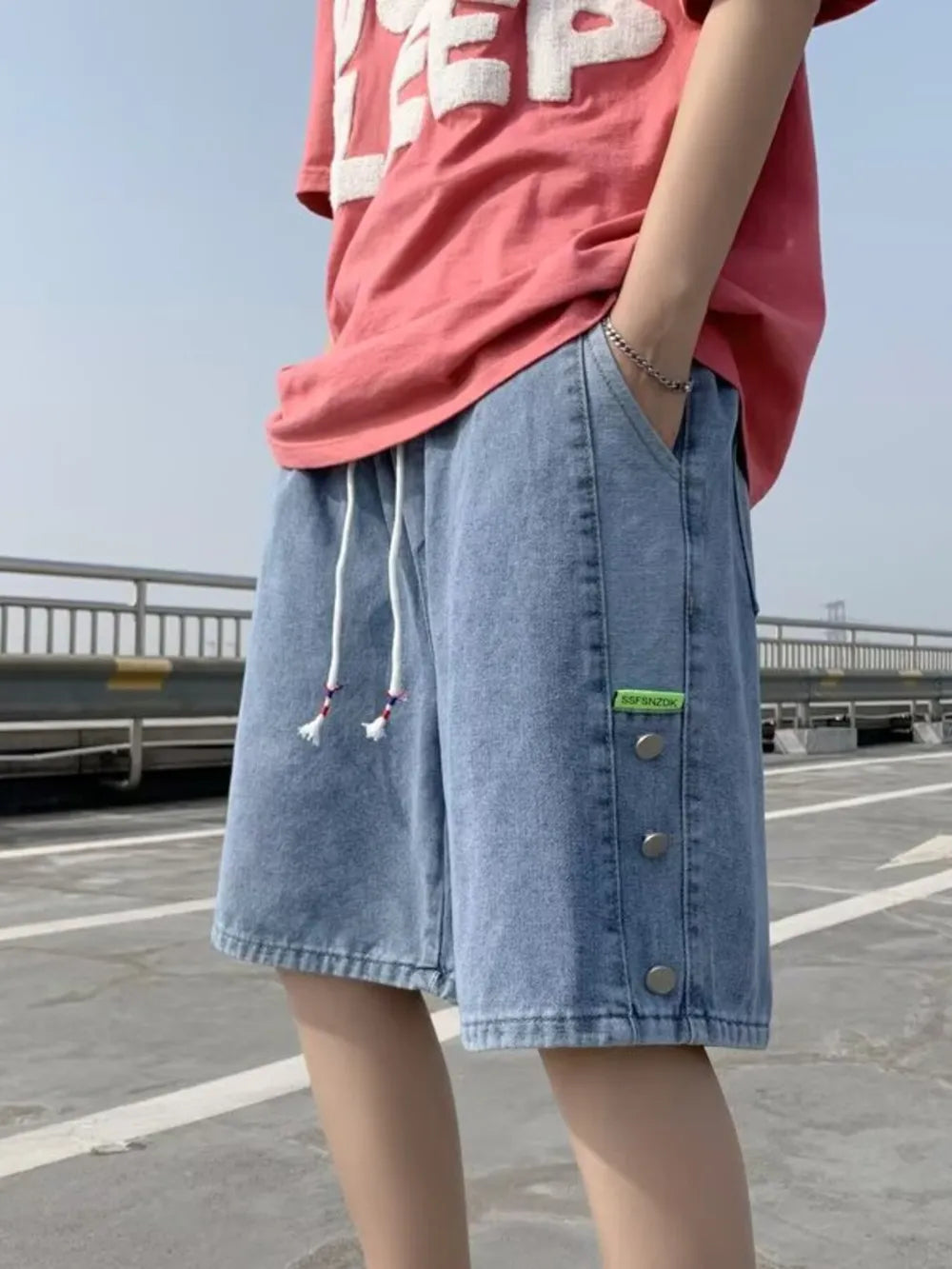 Blue denim shorts with adjustable drawstring and button detail