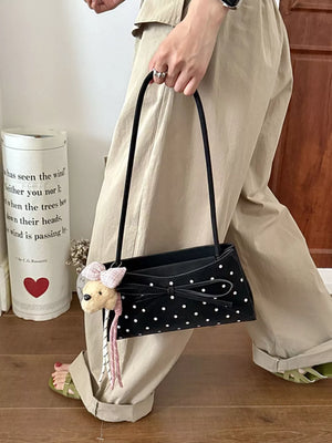 shoulder bag in black featuring bowknot decor and boxy fit
