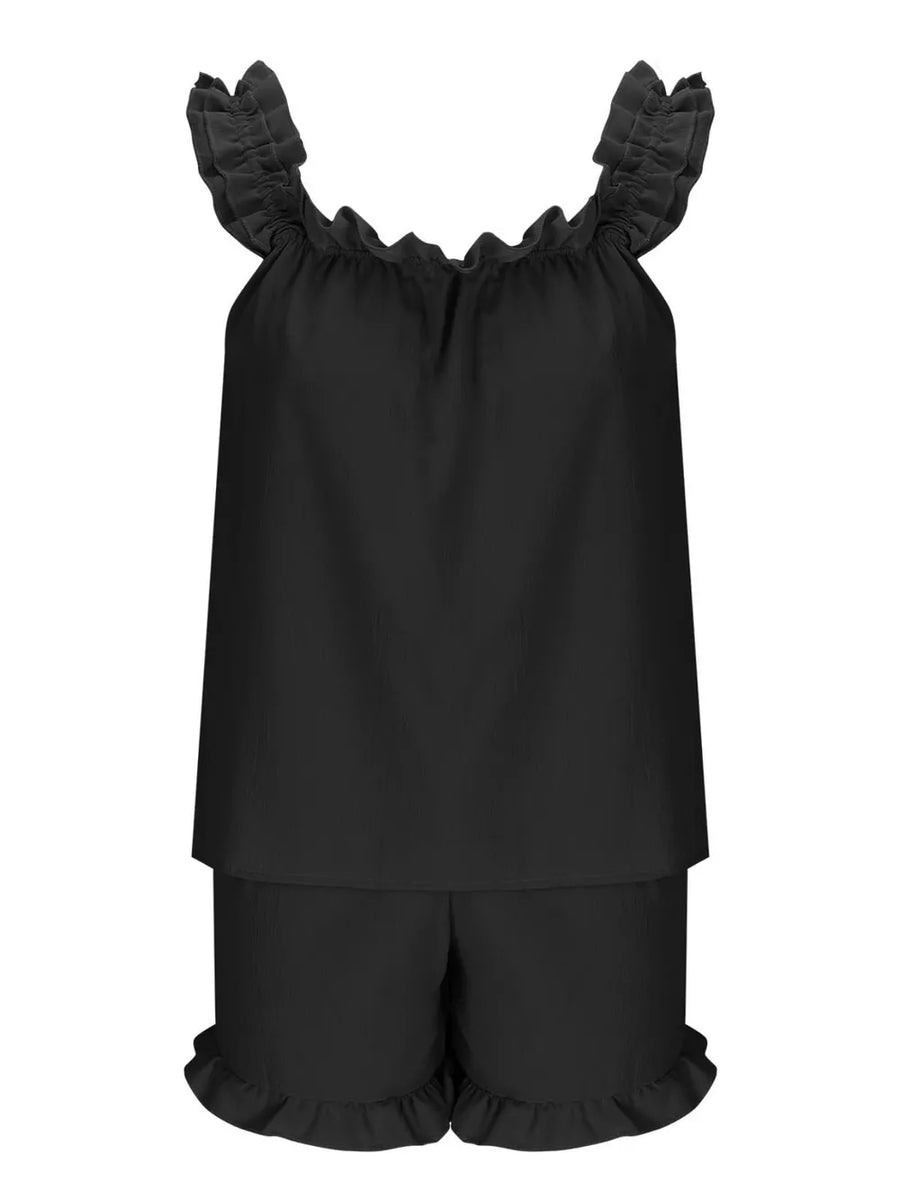 Black ruffled pajama set with off-the-shoulder top and shorts.