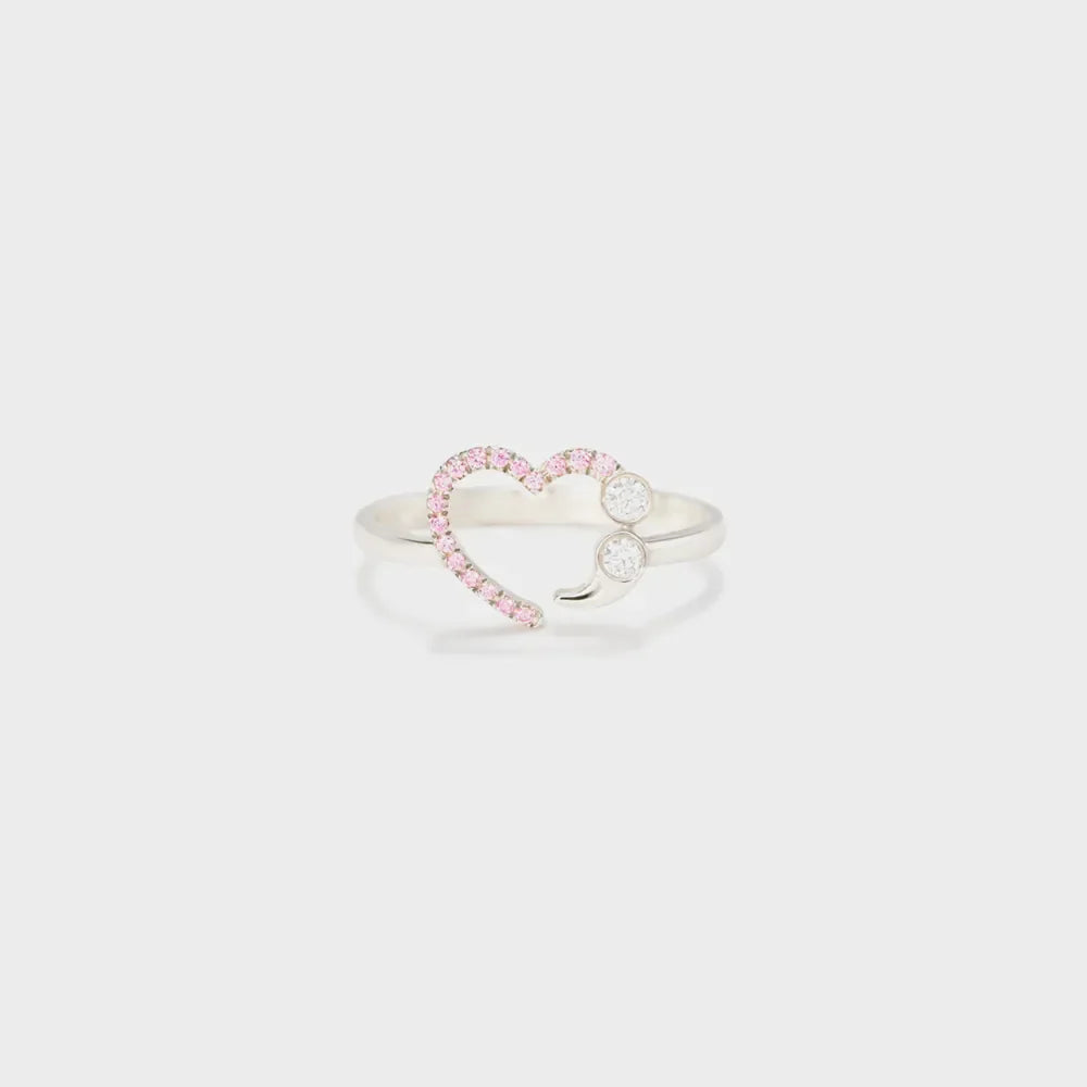 Sterling silver ring with a heart and semicolon design featuring pink stones and clear gems.