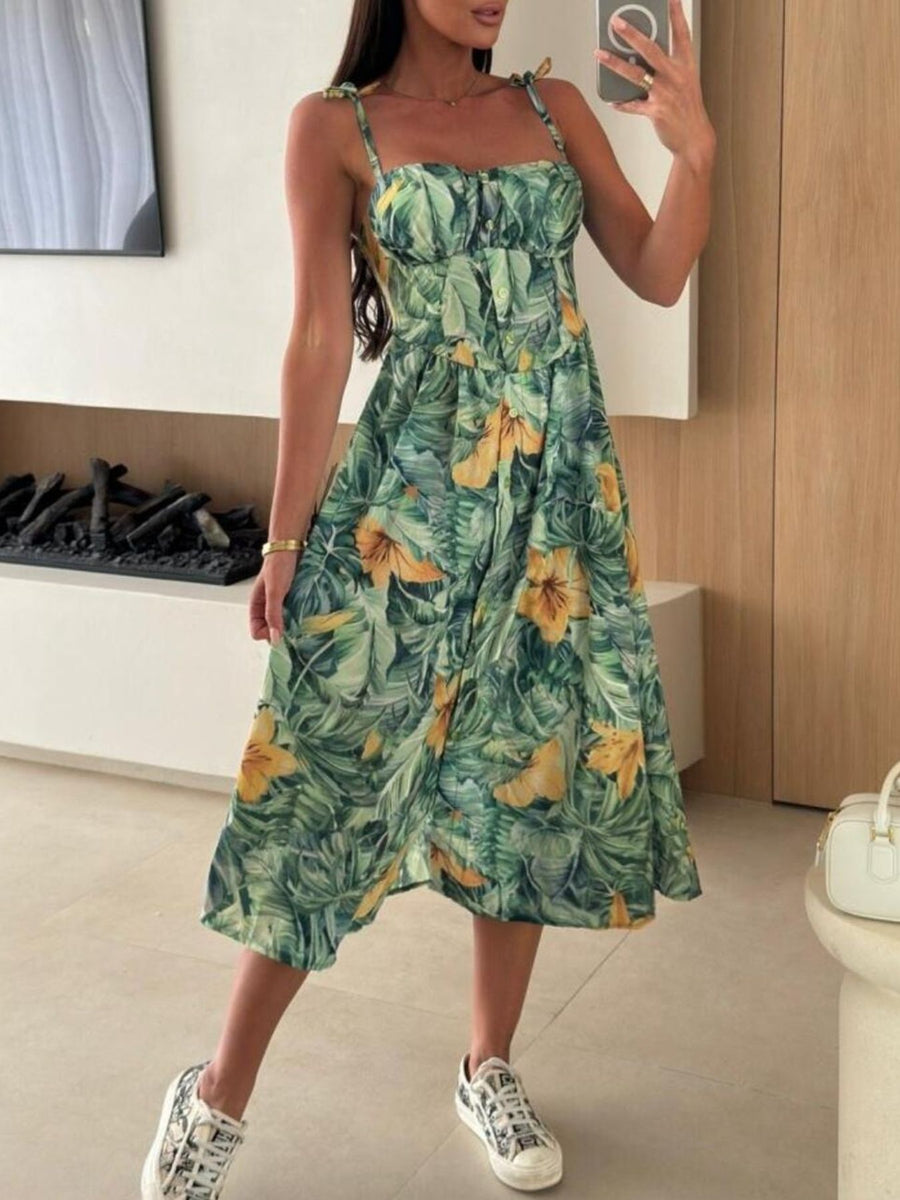 Tie-shoulder midi dress with tropical floral print and adjustable straps.