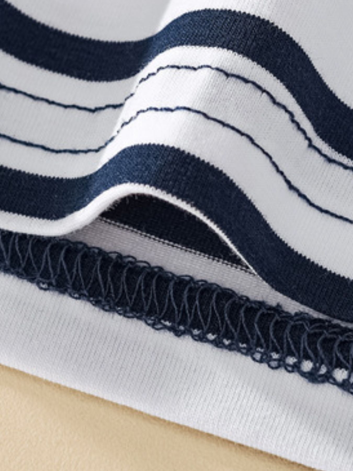 Toddler navy and white striped cotton t-shirt with detailed stitching.