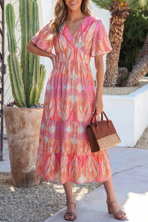Paisley print V-neck short sleeve midi dress in burnt coral with tiered skirt.