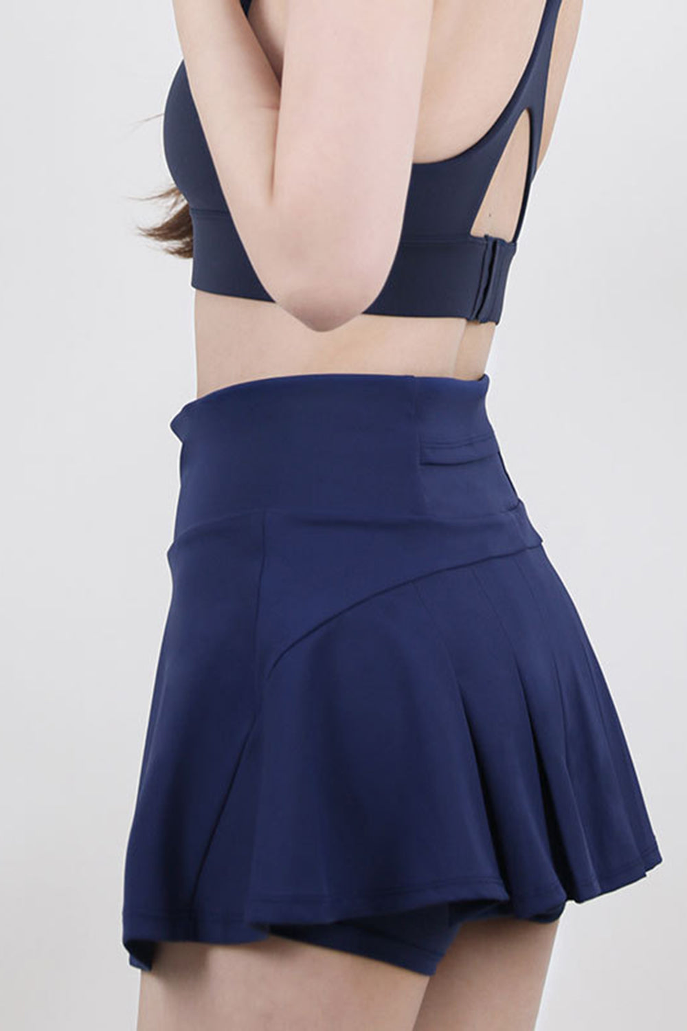 Dark blue flared skort with built-in shorts and a high-rise waist.