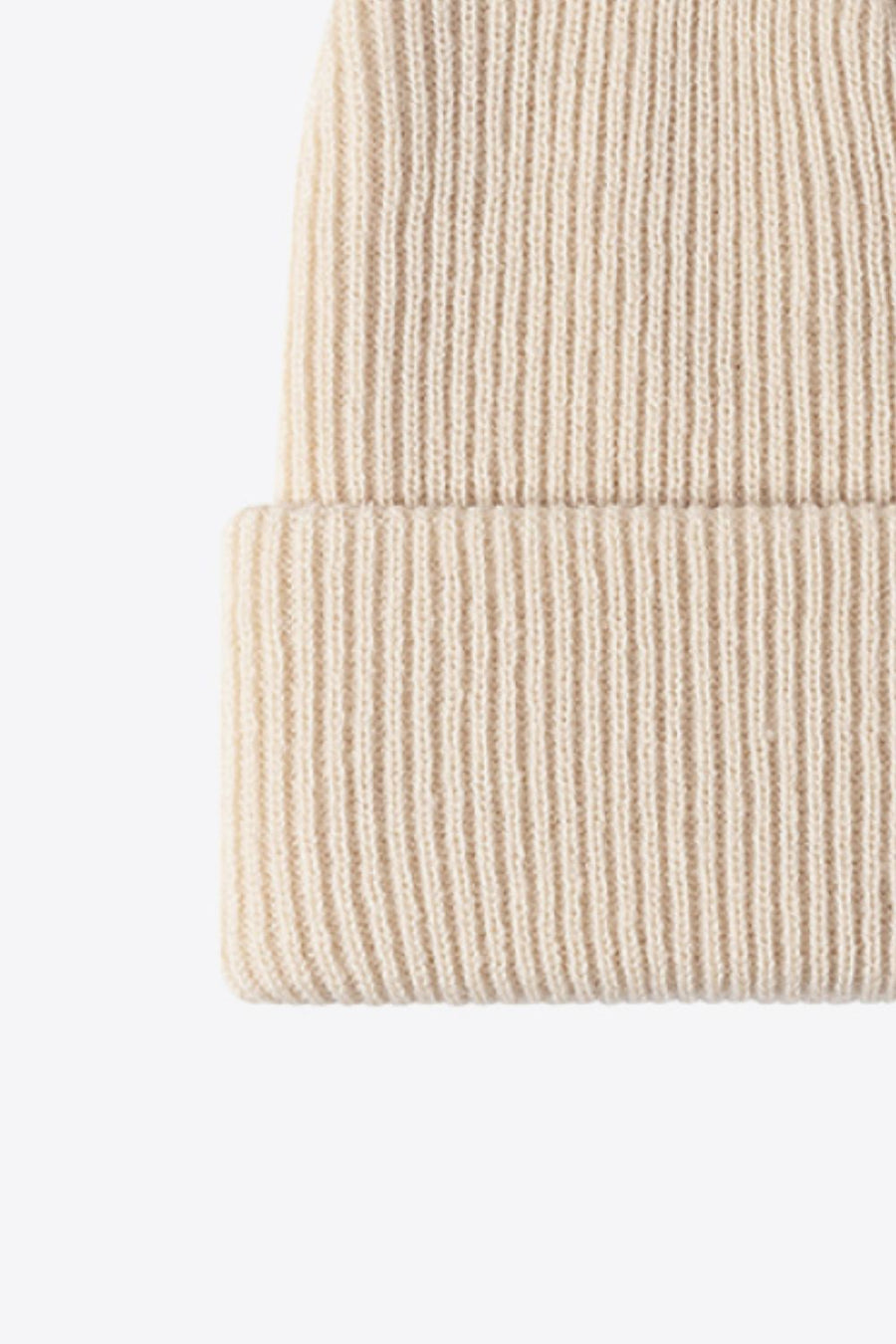 Beige ribbed knit beanie with a cuffed hem