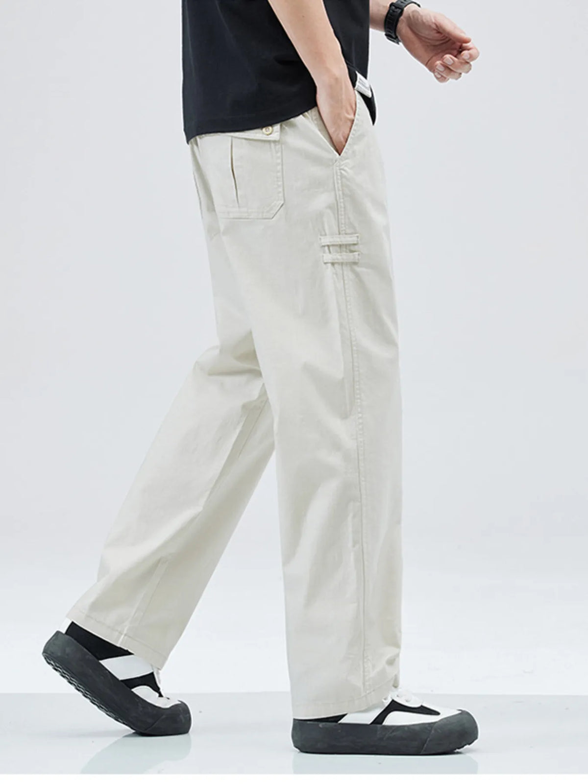 Beige casual straight leg trousers with a loose fit and buttoned back pocket.