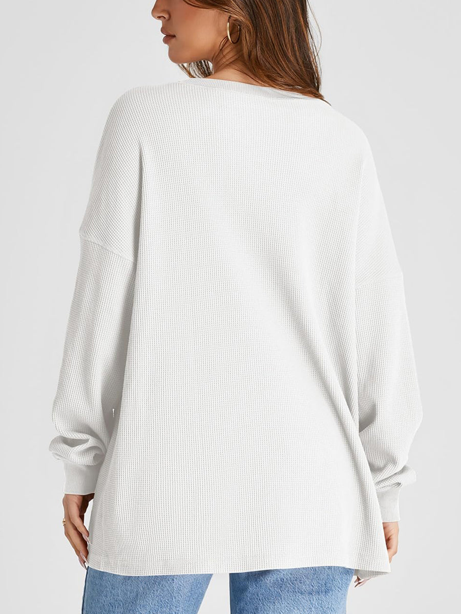 White waffle knit raglan sleeve sweatshirt with crew neck and relaxed fit.