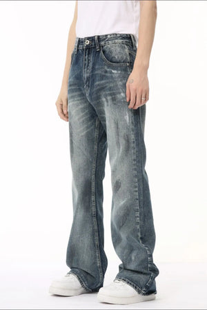 Baggy distressed denim flare jeans in medium wash, featuring a relaxed fit and subtle whiskering.