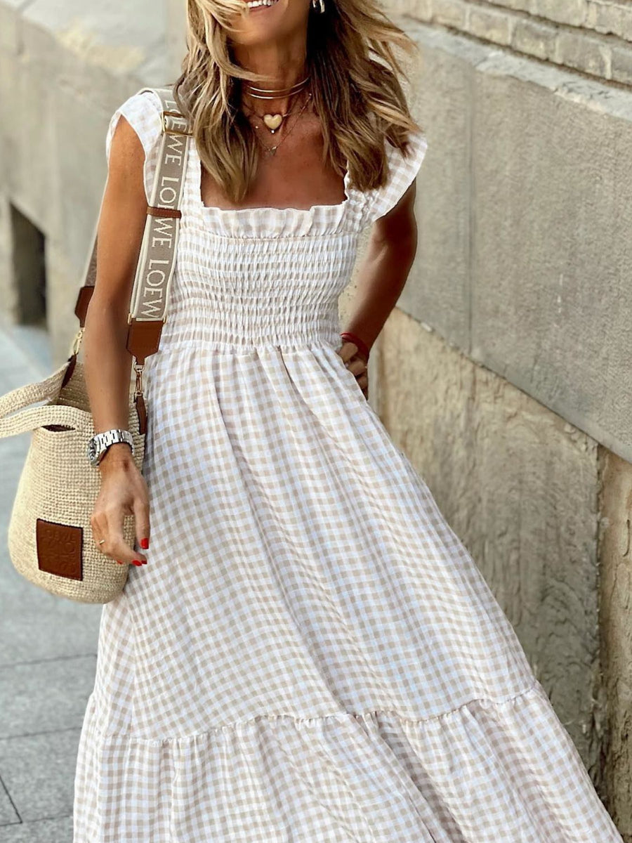 Beige gingham ruffled sleeve maxi dress with smocked bodice and tiered skirt.