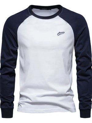 White long sleeve raglan tee with navy sleeves and a small embroidered logo.