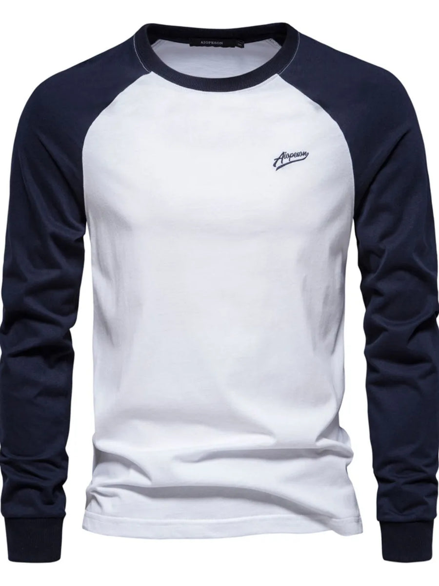 White long sleeve raglan tee with navy sleeves and a small embroidered logo.