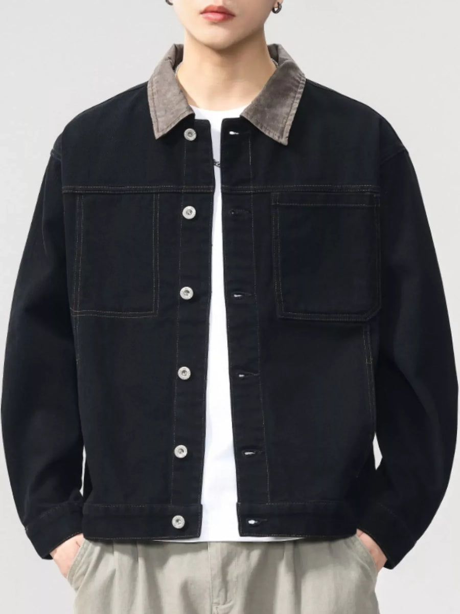 Black cotton jacket with contrasting collar and button front, featuring chest pockets.