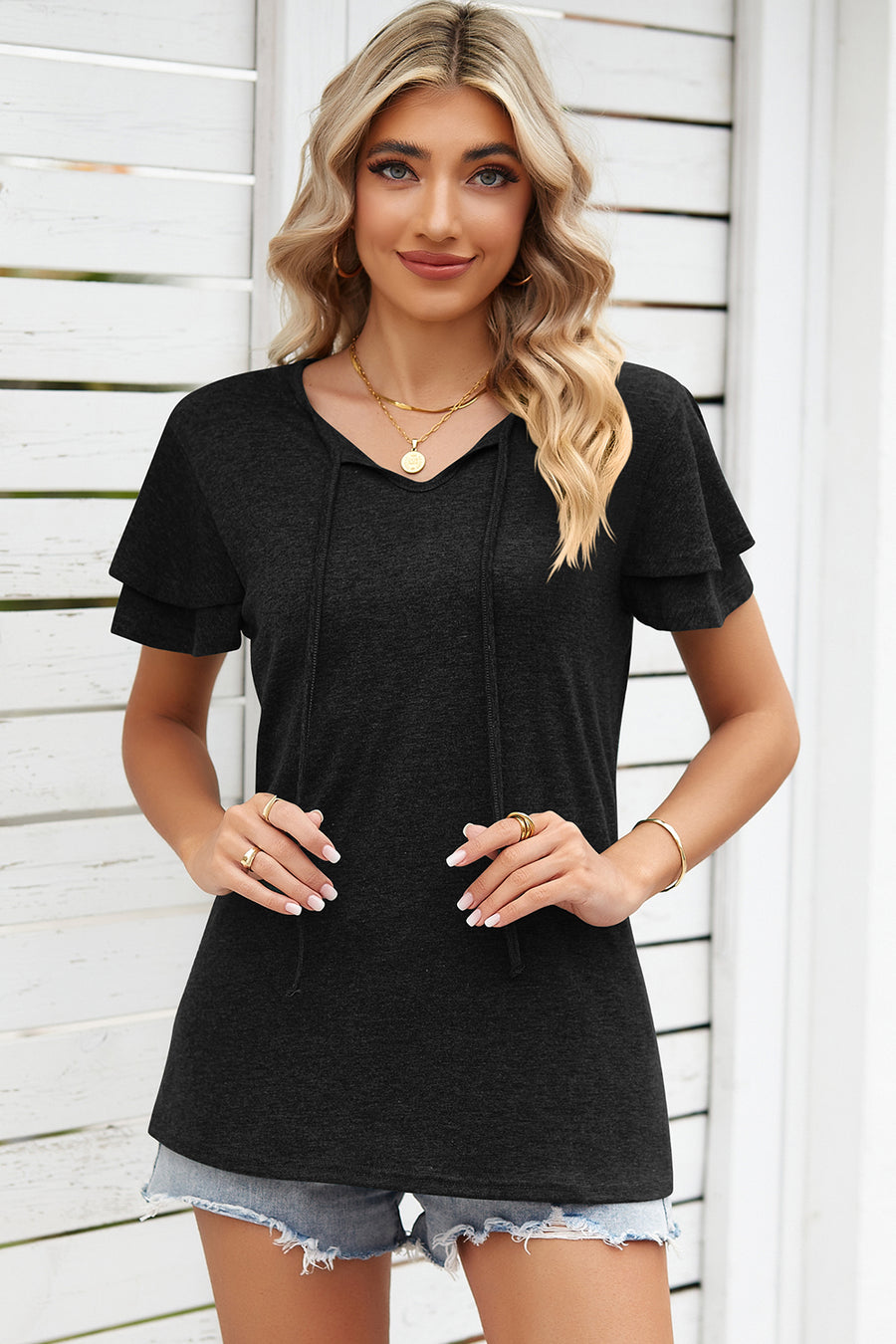 Black flutter sleeve henley tee with tie neck and layered sleeves.