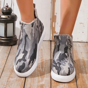 Green camouflage canvas zip-up sneaker booties with faux fur trim.