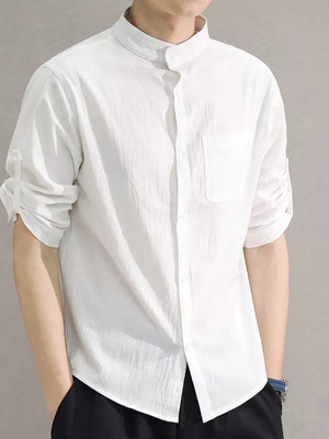 White cotton button-down shirt with roll-up sleeves and chest pocket