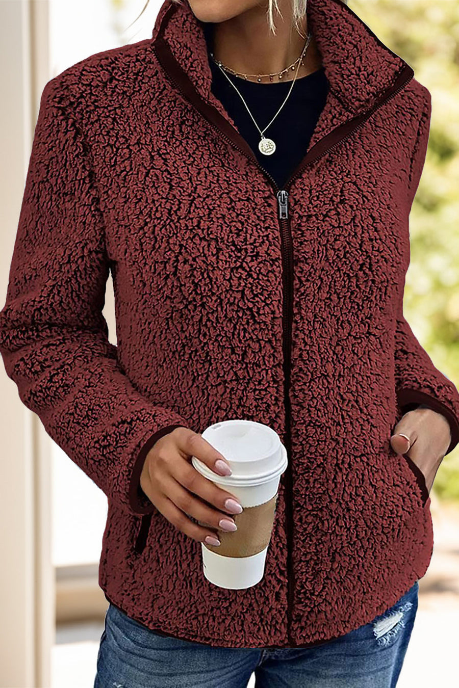 Burgundy teddy fleece zip-up jacket with a stand collar and pockets.