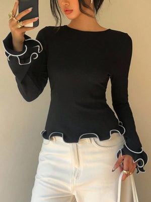 Black long sleeve t-shirt with ruffled white trim on cuffs and hem.