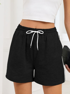 Black heathered jogger shorts with white drawstring and sporty side trim.