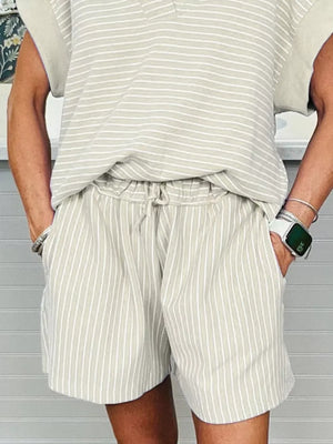Beige striped cotton polo shirt and drawstring shorts ensemble with pockets.