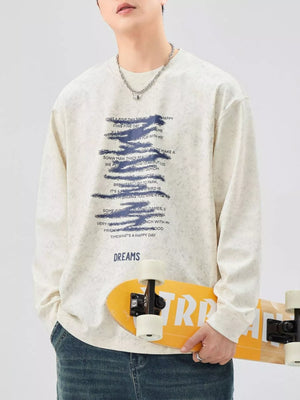 Oversized long-sleeve tee in Apricot with graphic text print and "DREAMS" graphic.