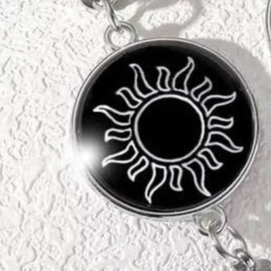 silver bracelet featuring glow-in-the-dark and symbolic