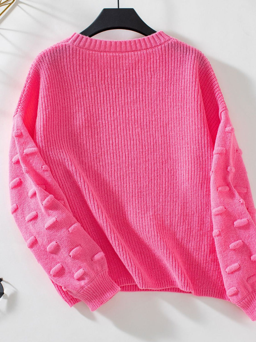 Hot Pink knit sweater with textured sleeve details and ribbed cuffs.