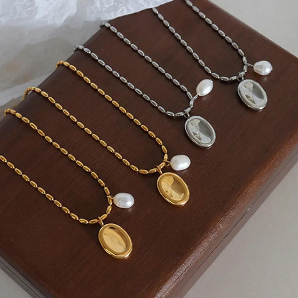 Gold and silver oval medallion necklaces with pearl accents