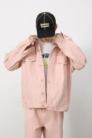 Blush pink denim trucker jacket with button front and chest pockets.