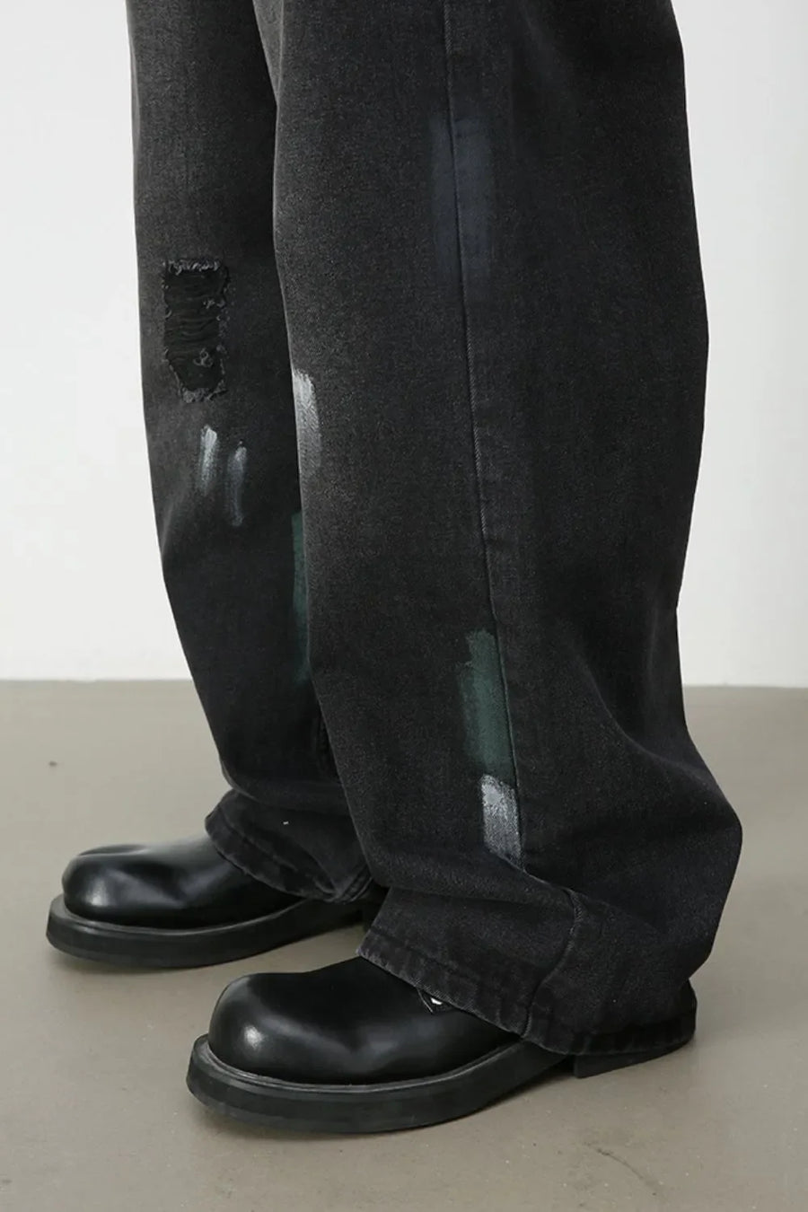 Dark wash wide-leg jeans with distressed details and painterly brushstrokes.