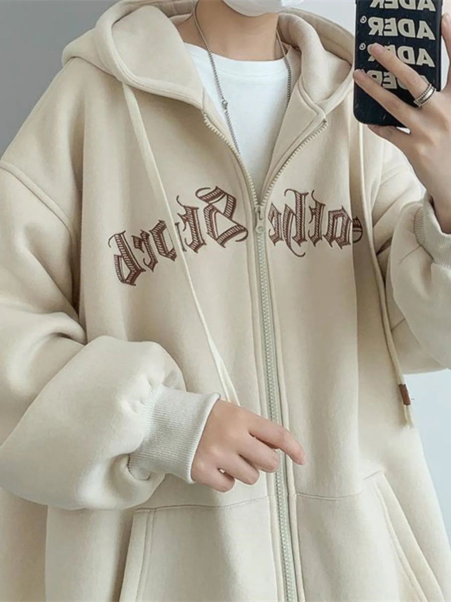 Apricot zip up hoodie with drawstring, graphic print, and ribbed cuffs.