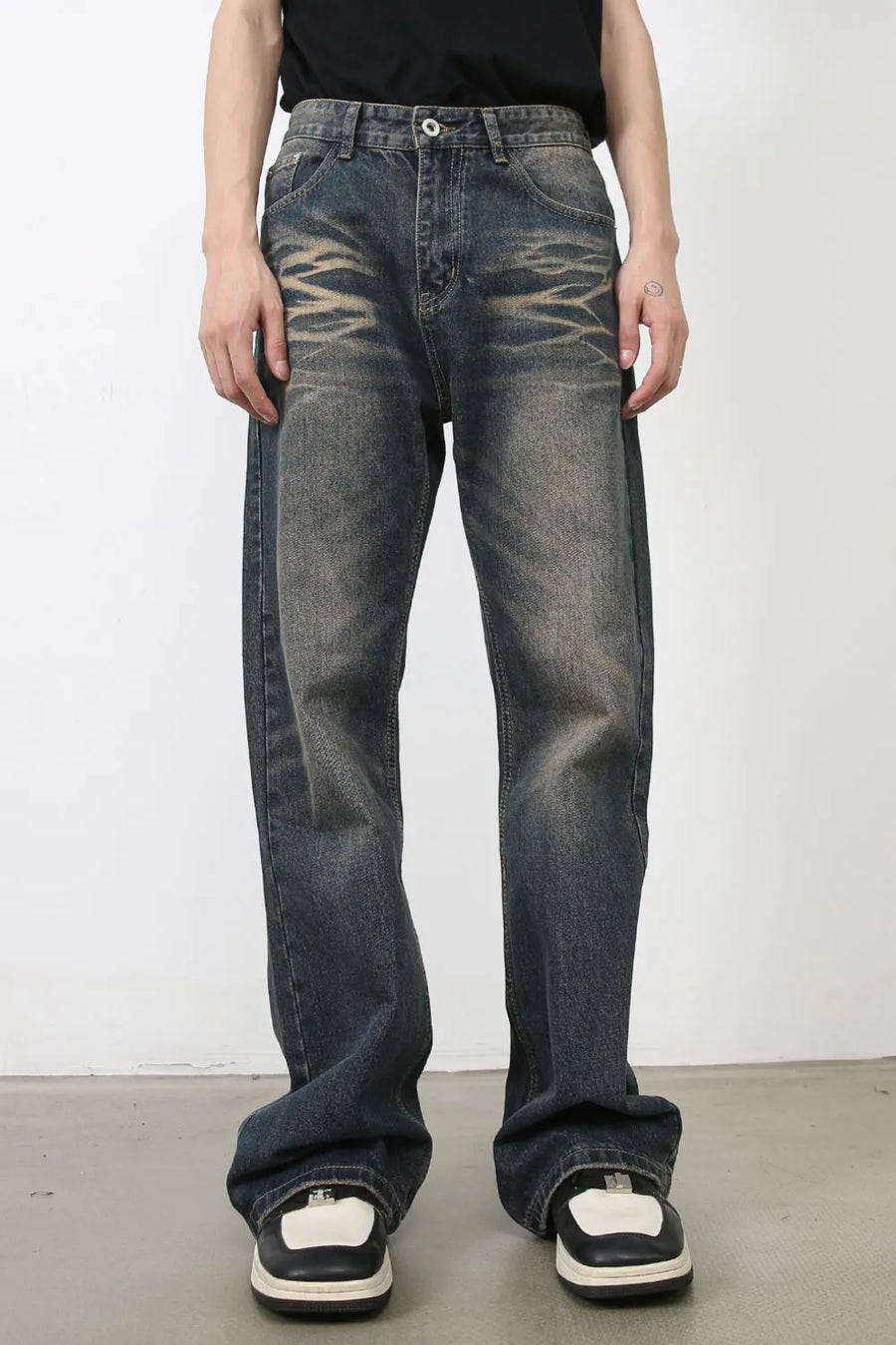 Faded wash wide-leg jeans in medium blue denim with distressed detailing.