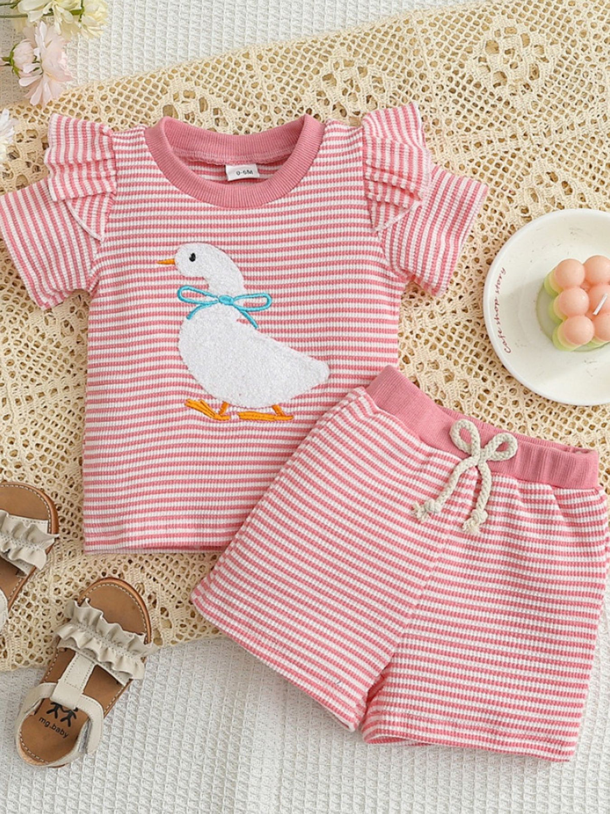 Pink striped baby set with embroidered duck and ruffle sleeves.