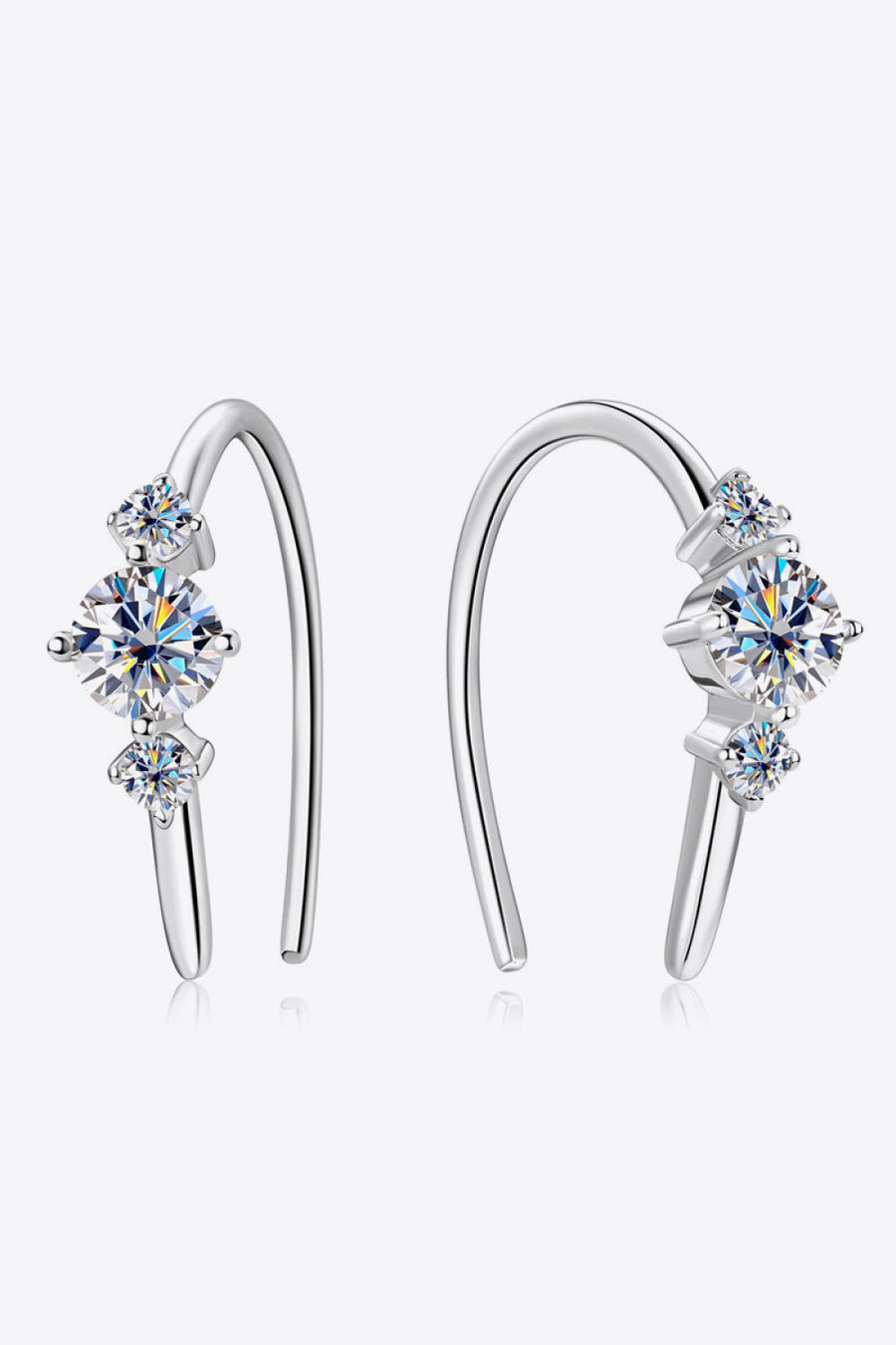 Silver ear climbers with three sparkling diamonds, a celestial design.