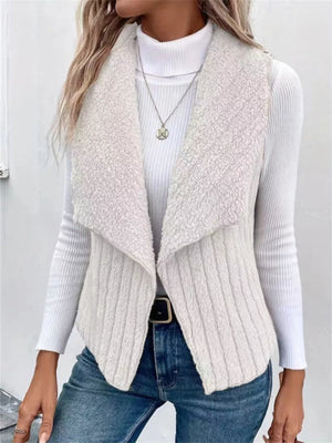 White open front fleece vest with shawl collar, ribbed texture, and open sides.