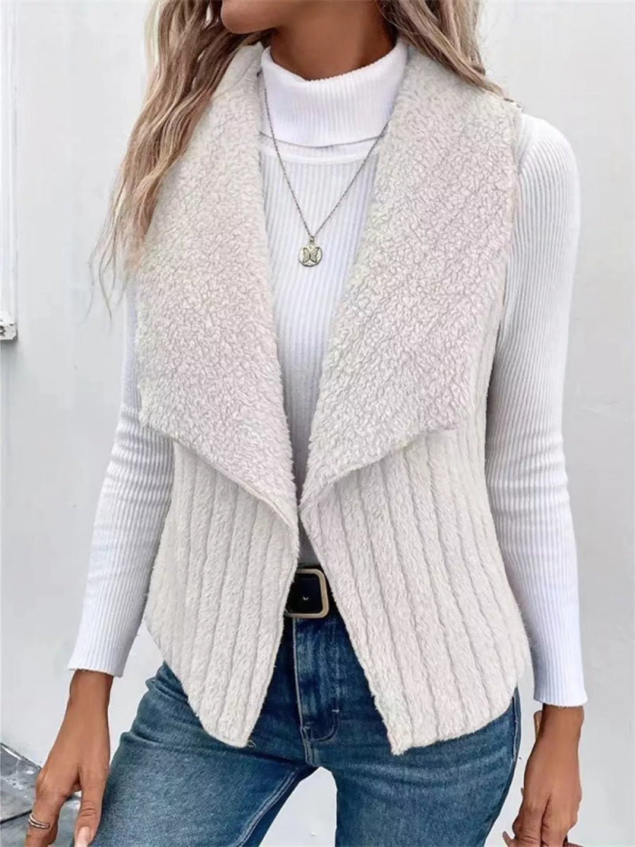 White open front fleece vest with shawl collar, ribbed texture, and open sides.