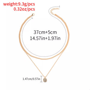 Gold double layered pendant necklace with small crystal charm.